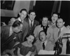 At a rehearsal for radio broadcast of songs from The Wizard of Oz.  Standing are Bert Lahr, Ray Bolger, MGM executive L.K. Sydney, E.Y. Harburg, Meredith Wilson, & publisher Harry Link.  Judy Garland & Harold Arlen are at the piano.